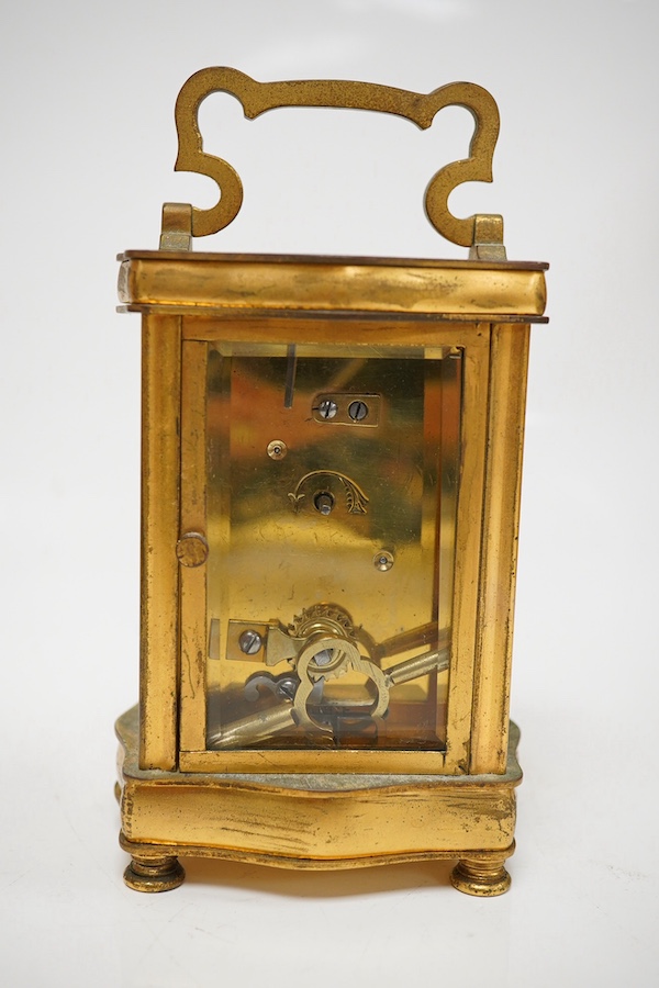 A late 19th / early 20th century ornate French gilt metal cased carriage timepiece, the dial inscribed Henry Birks, with key, 15cm high. Condition - fair, untested